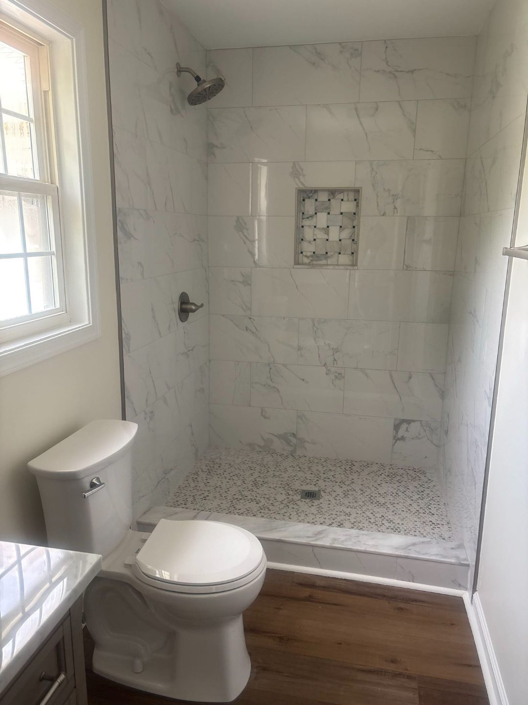 Bathroom after renovation with marble tile walk in shower