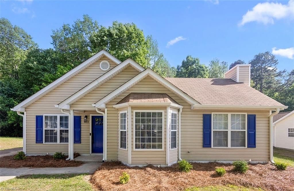 Exterior after renovation with new shutters and landscaping